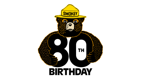 Logo of Smokey Bear wearing a yellow hat with his arms around "80th" and the word birthday underneath.